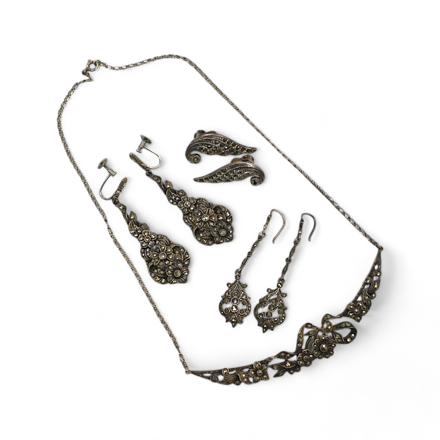 Two pairs of white metal and marcasite earrings, a similar pair of ear clips and a necklace. Condition - poor to fair